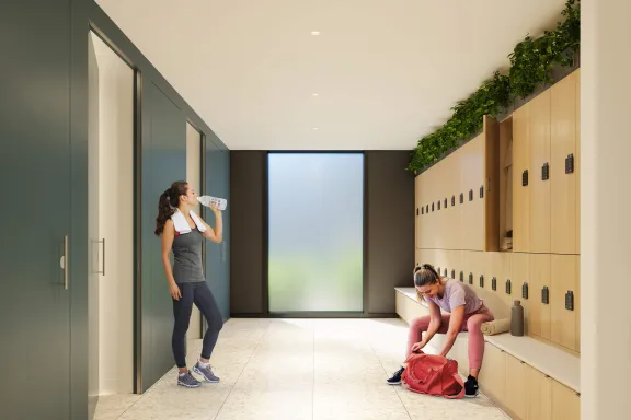 Two women in activewear standing in the luxury washrooms at New Yards Haymarket, Edinburgh