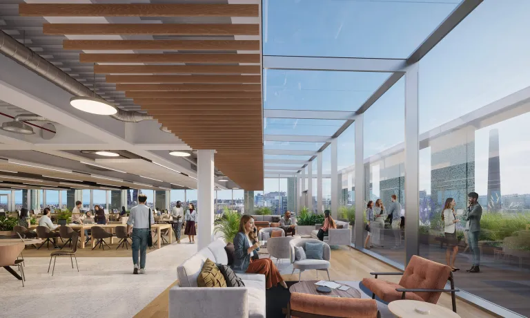 Lounge area in open plan office space featuring floor to ceiling windows with views of Edinburgh